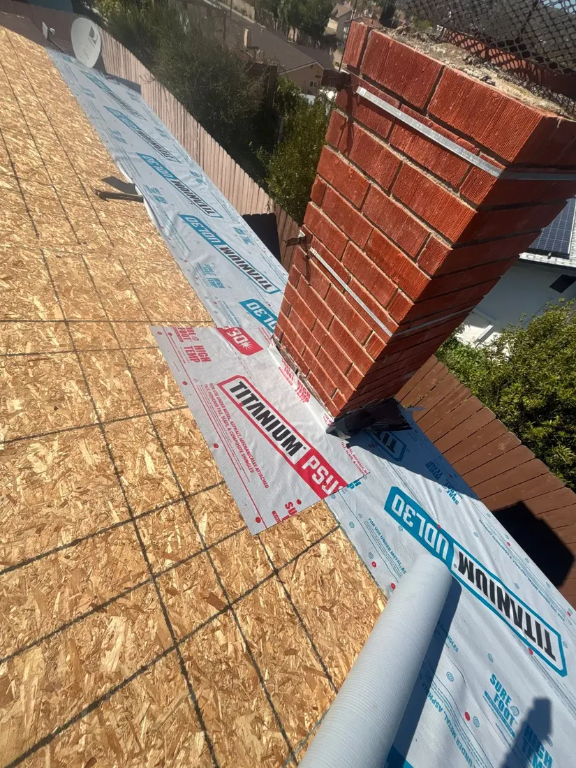 Self-adhered membrane detail installed around a brick chimney