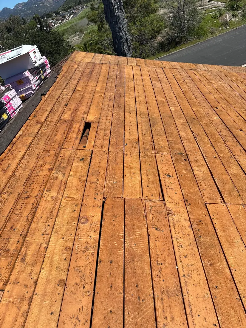 Existing plank roof deck exposed during asphalt shingle tear-off