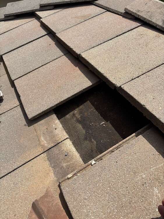 Concrete flat roof tile opening showing the roof layer beneath