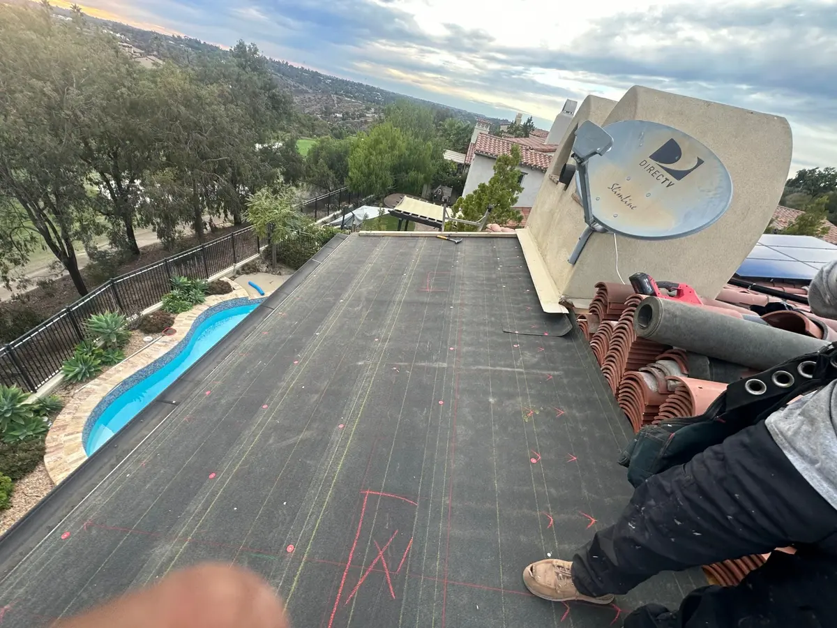 New underlayment installed beneath a clay tile roof