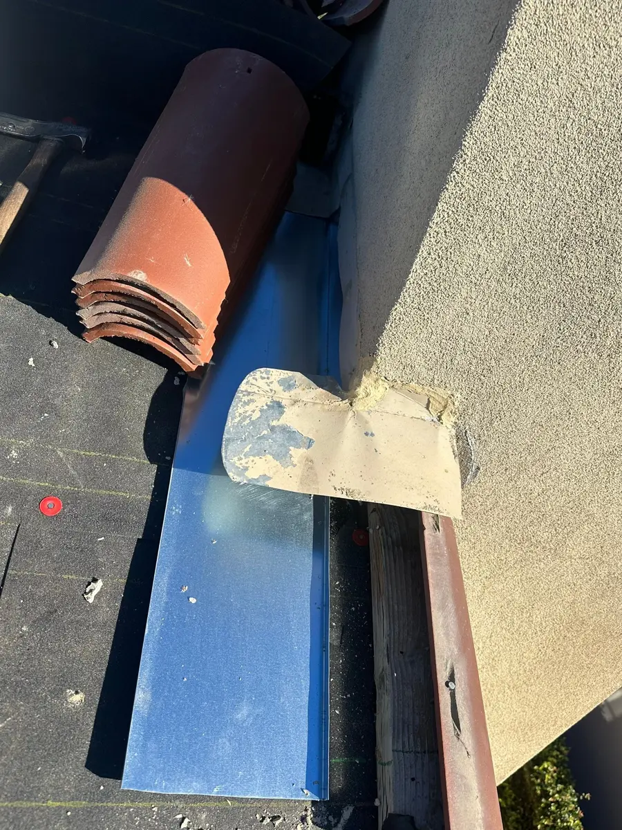 Updated metal sidewall flashing under two-piece clay tile