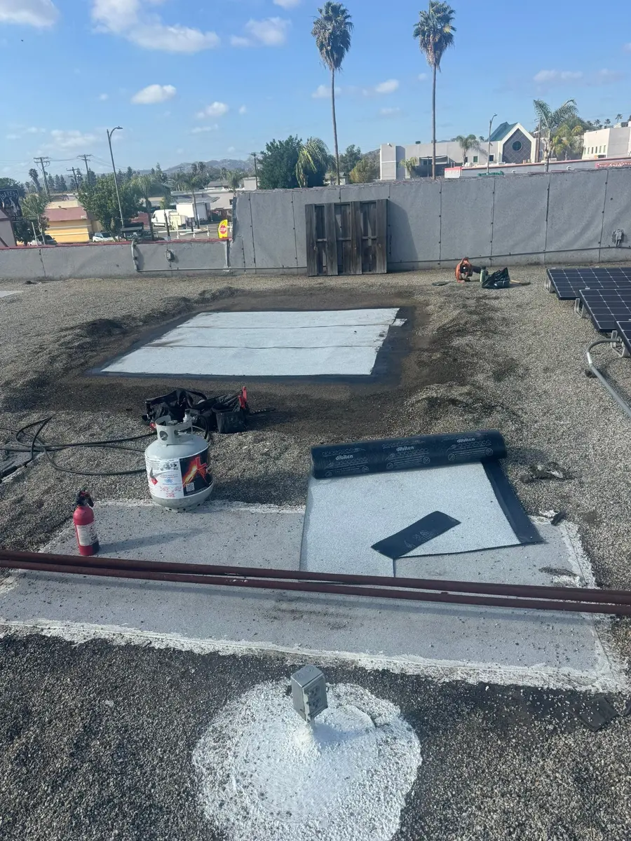 Overall view of two completed built-up roof repair areas