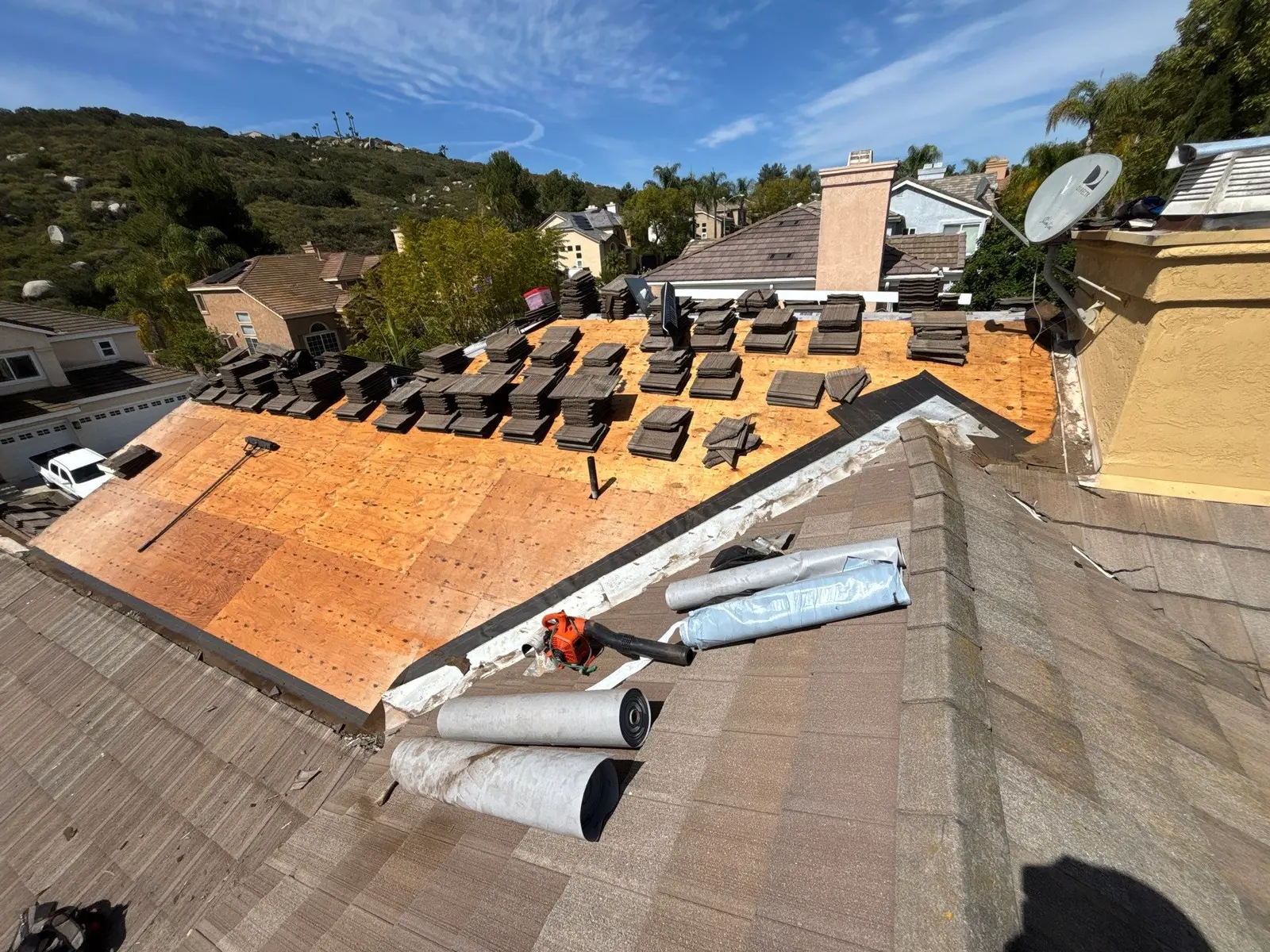 Existing Monier concrete tiles staged while the roof deck is exposed