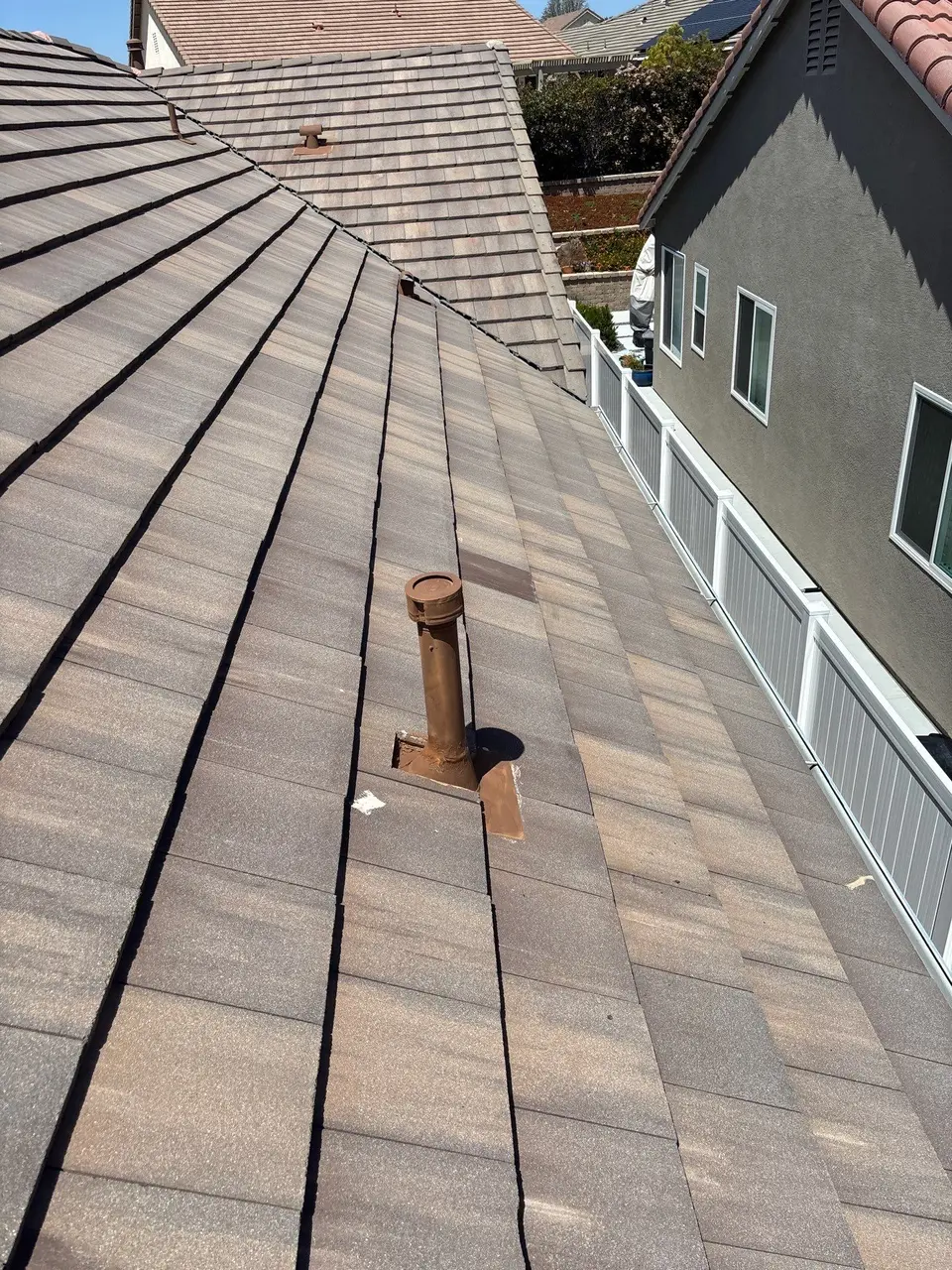 Completed vent flashing maintenance on a concrete tile roof