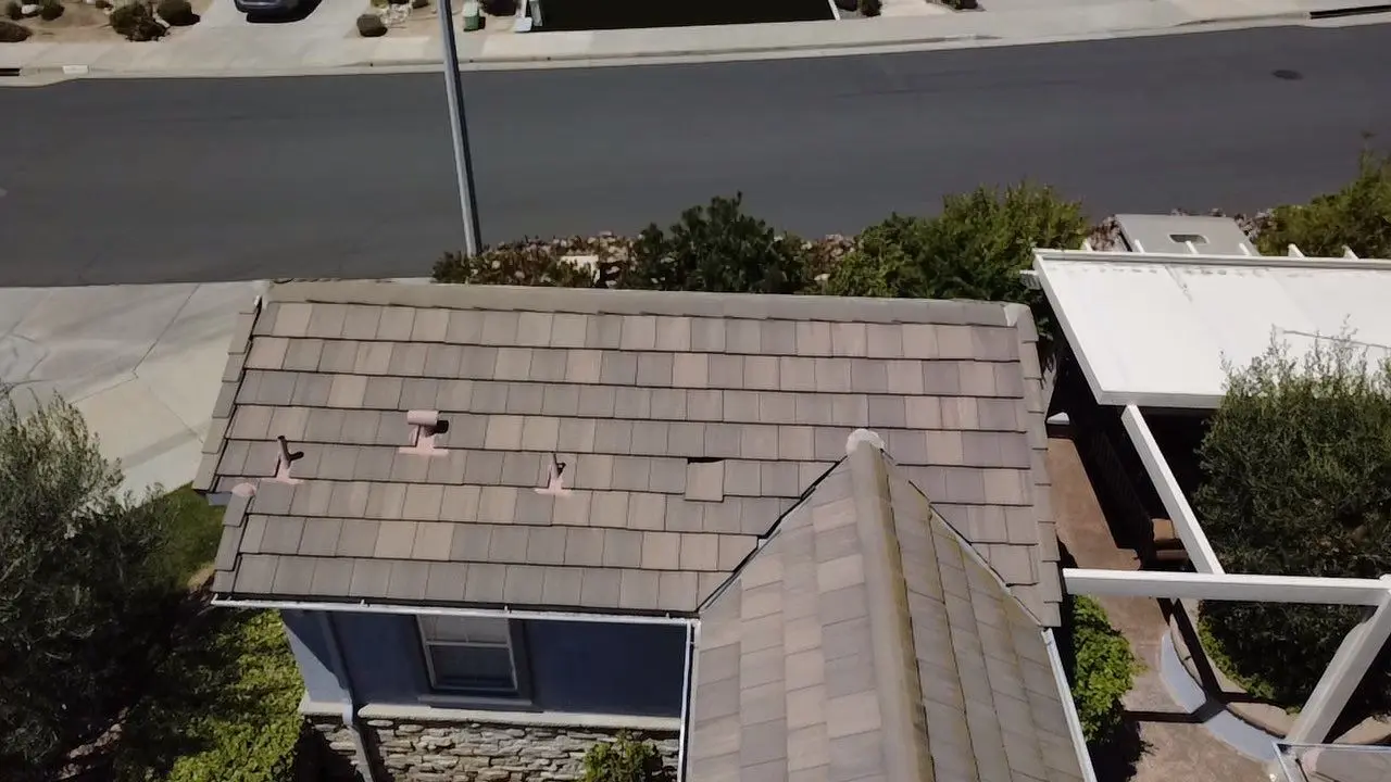 Concrete tile roof before maintenance with shifted tiles visible