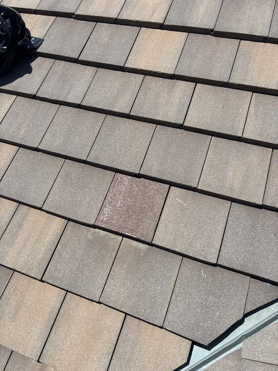 Compatible replacement concrete tile installed during roof maintenance