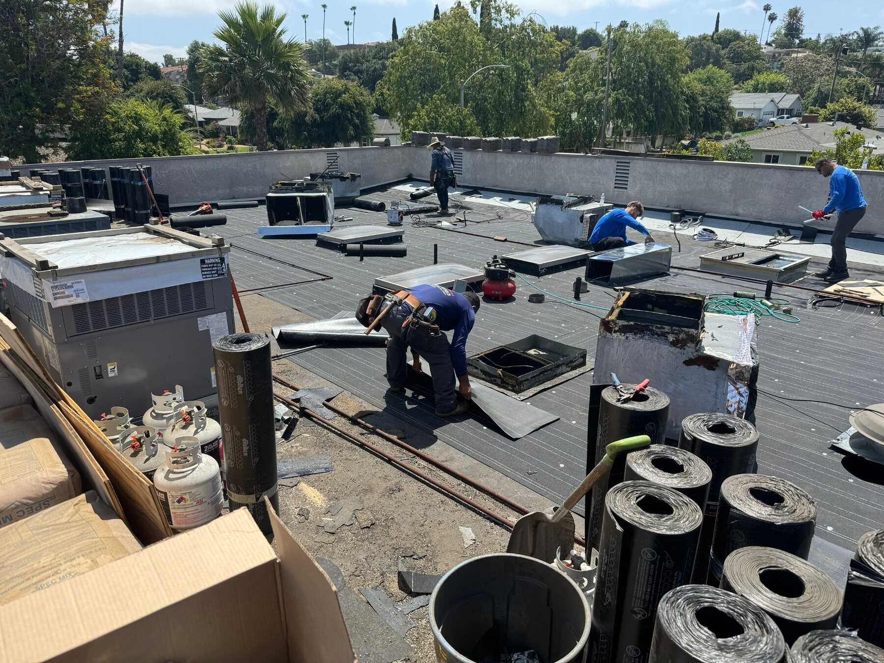 Zenith crew installing a low-slope modified bitumen roof
