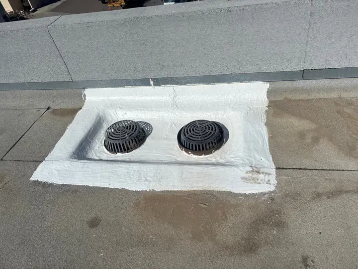Commercial roof drains after cleaning and reinforced sealant detailing