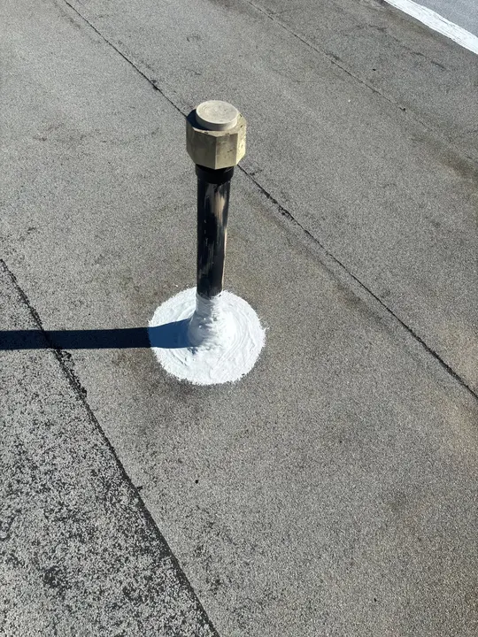 Commercial modified bitumen roof pipe penetration after professional sealant detailing
