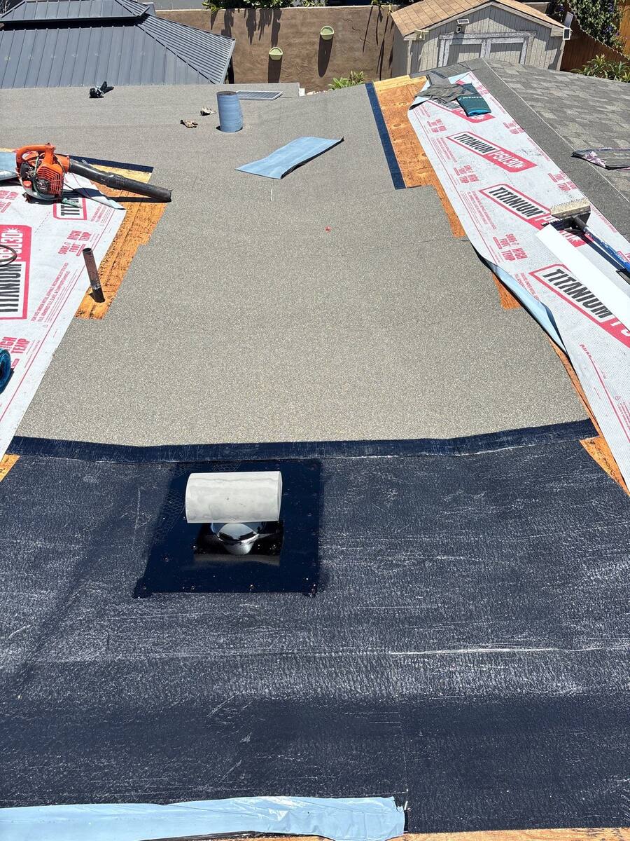 Modified bitumen roof detail around a vent and adjoining roof section