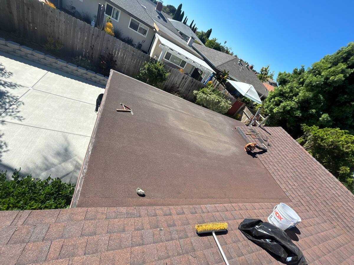 Existing brown low-slope patio roof before silicone restoration