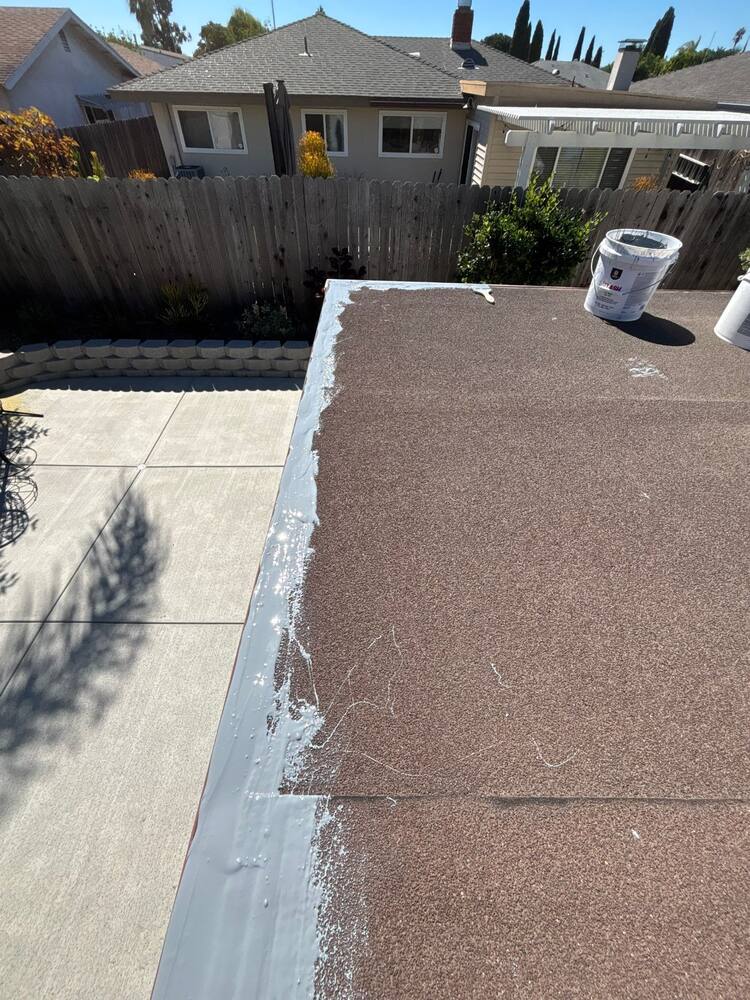 Silicone mastic installed along an edge before coating