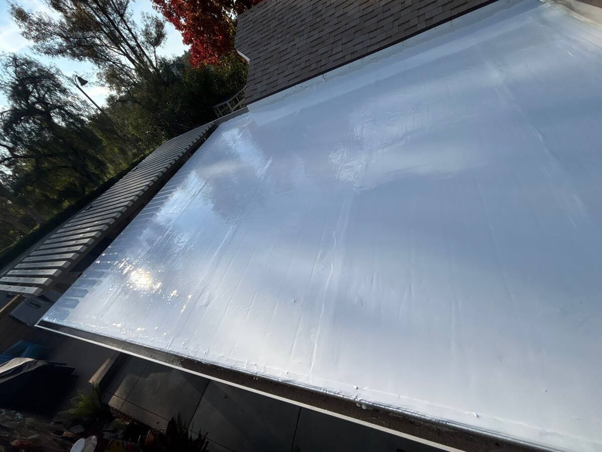 Reflective white silicone coating installed on a low-slope roof