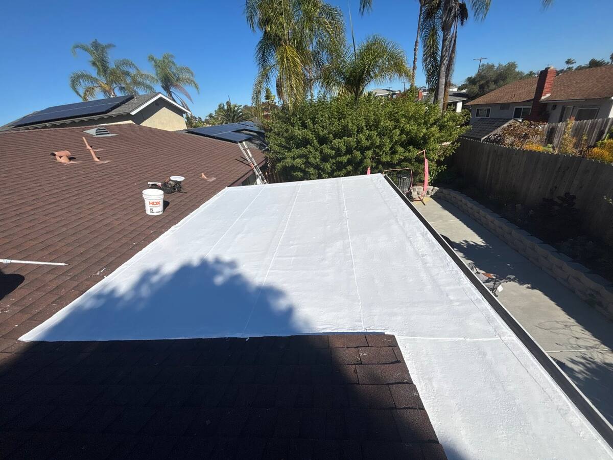 Fresh white silicone coating on a finished patio roof