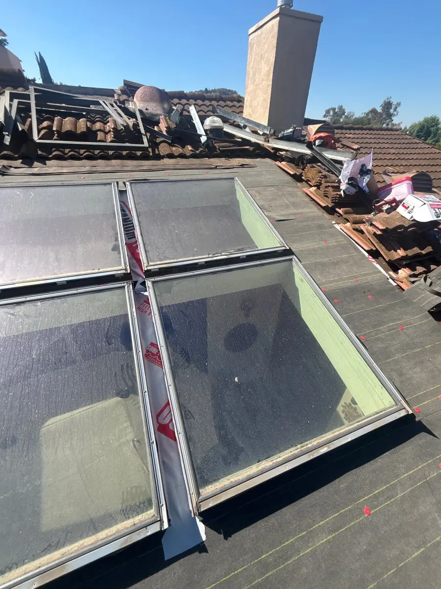 Skylight repair with new underlayment and peel-and-stick membrane visible between frames