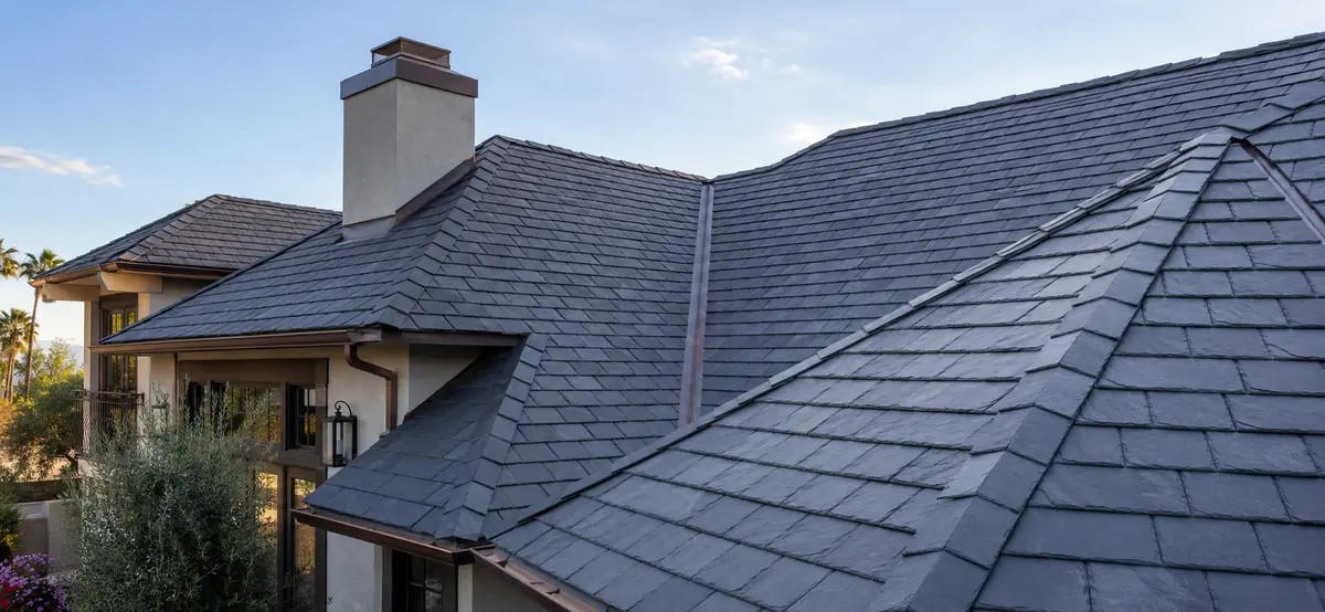 Representative natural slate roof with intersecting roof planes and metal valley