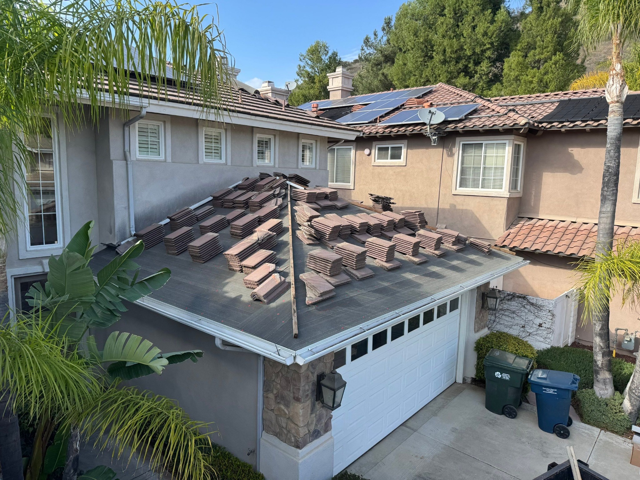 Zenith crew stages roof tile during a tile lift and lay before underlayment replacement