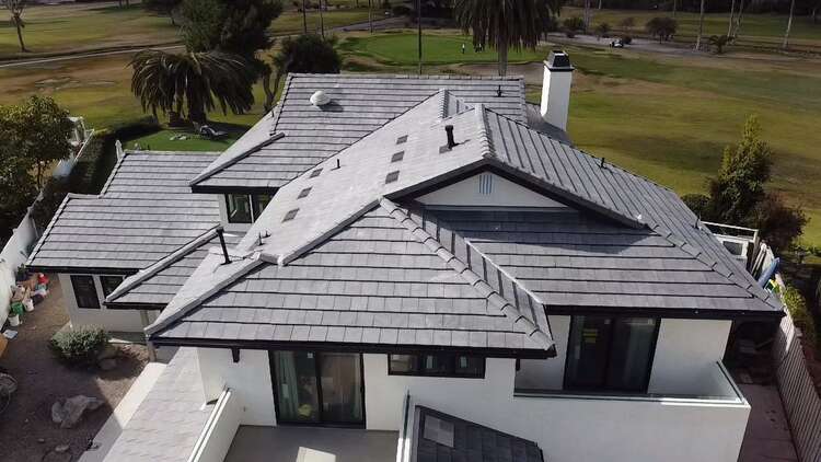 Finished grey concrete tile roof replacement on a two-story home