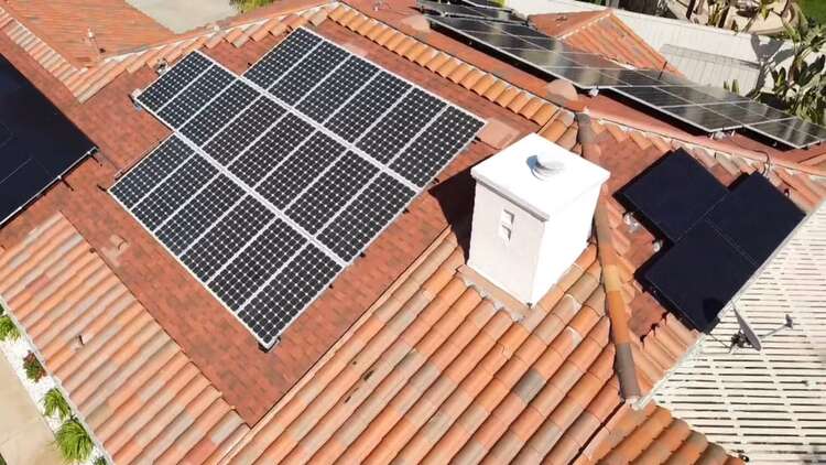 Tile roof with solar panels installed within a planned tile border