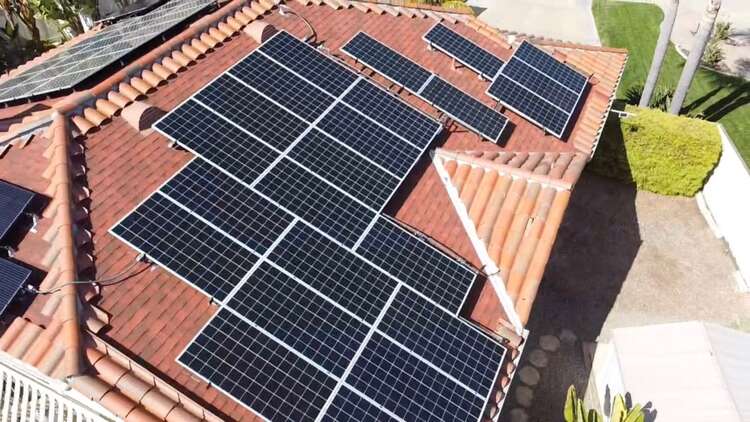 Solar panels integrated with a red tile roof