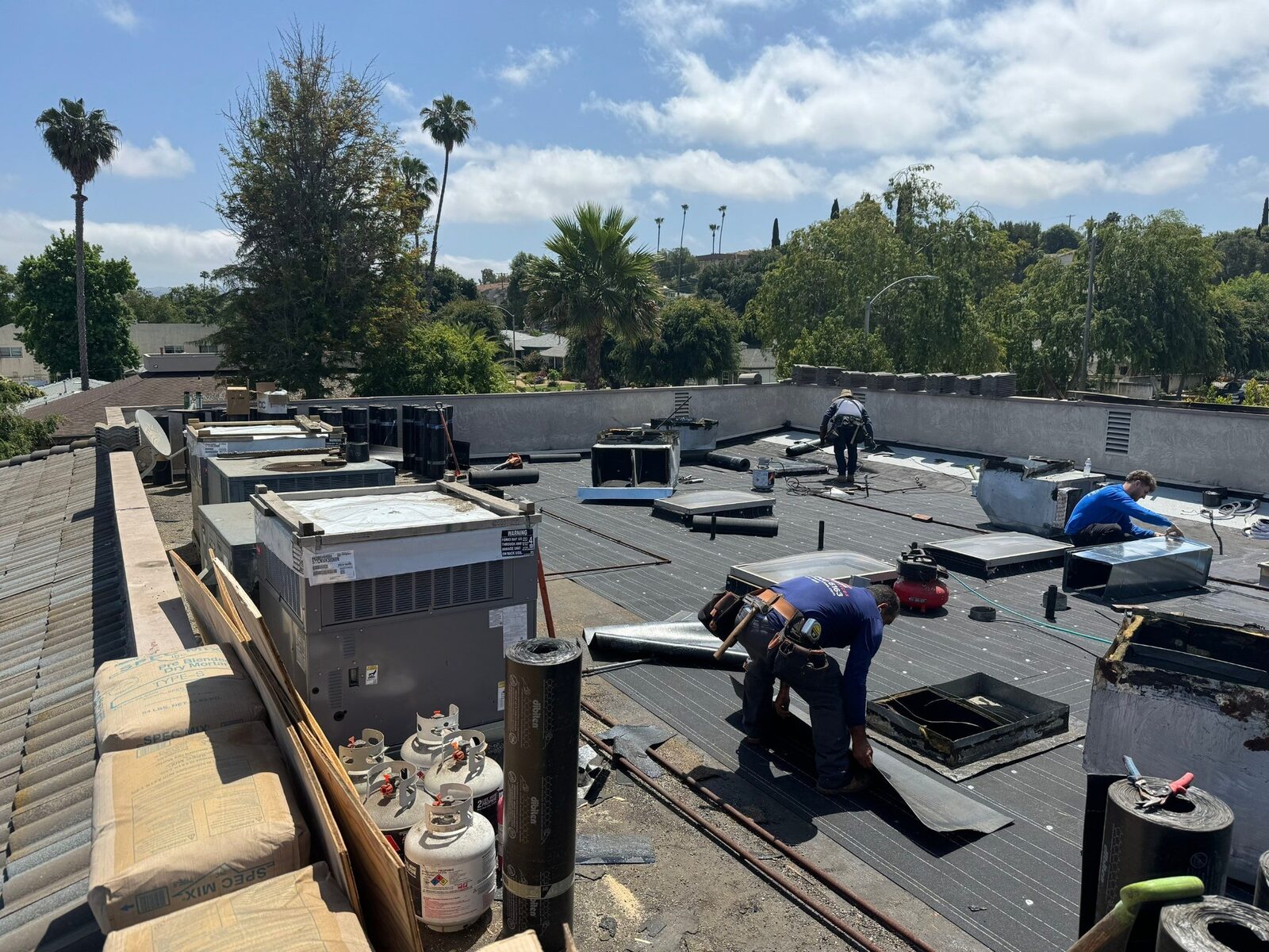 Zenith Roofing crew installing a modified-bitumen roofing system around rooftop HVAC equipment