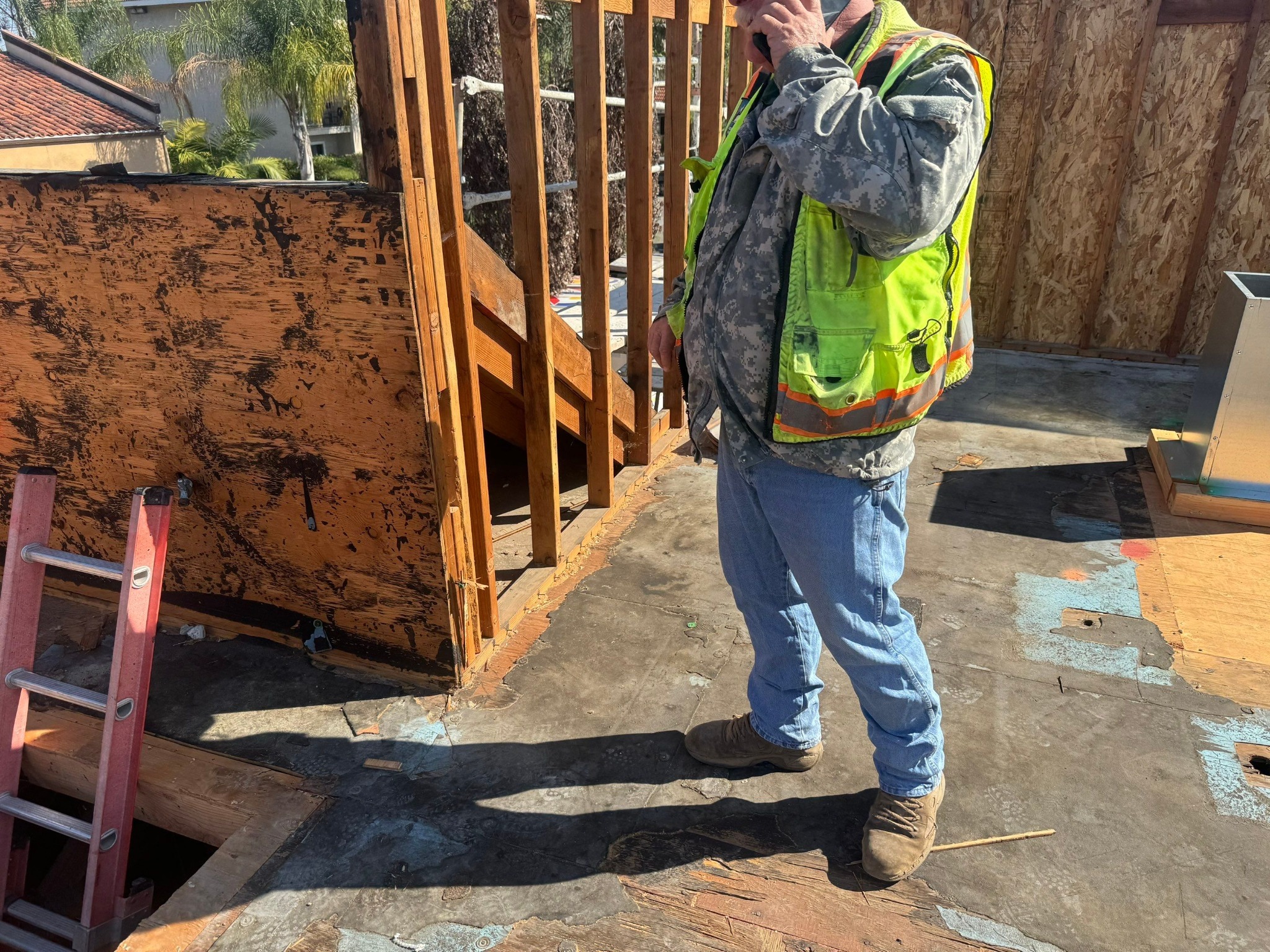 Existing low-slope roof opened for substrate and wall inspection